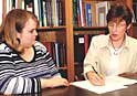 Janet Farmer, PhD, right, and Kathleen McCann Deidrick, PhD, discuss a manuscript