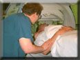 Technologist positioning patient for imaging procedure